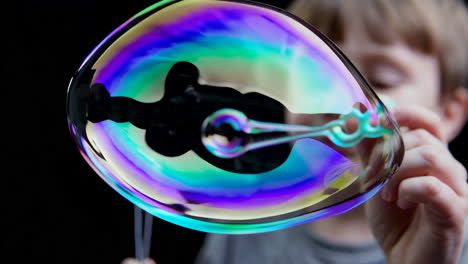a child playing with colorful soap bubbles