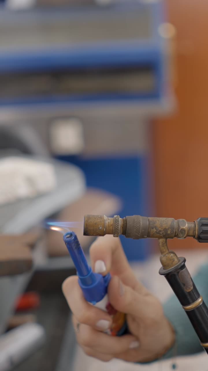 A person using a torch for crafting or metalworking