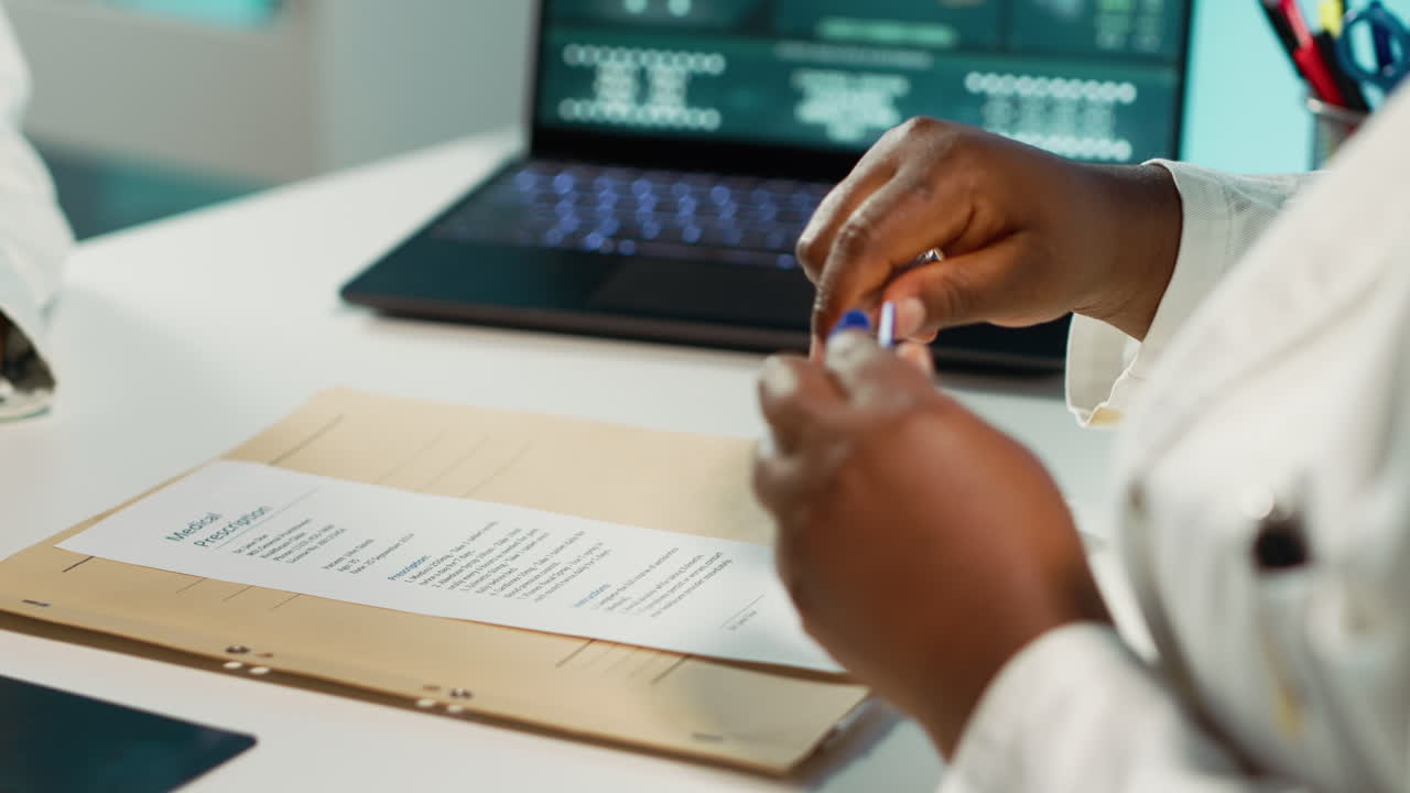 Physician signing the prescription paper to provide antibiotics to young girl