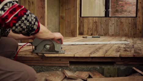 Cropped-View-Of-A-Man-Cutting-Wood-Plank-Flooring-Using-Electric-Circular-Saw