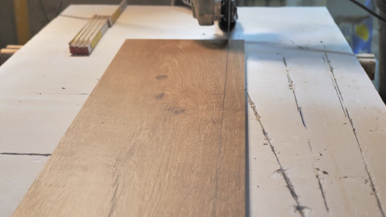 A master tiler cuts ceramic tiles. close up