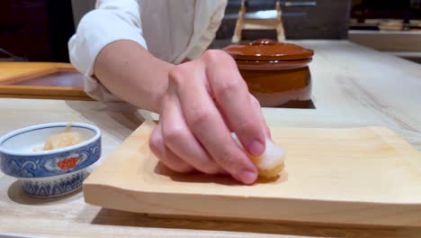 chef skillfully crafts nigiri sushi in bangkok