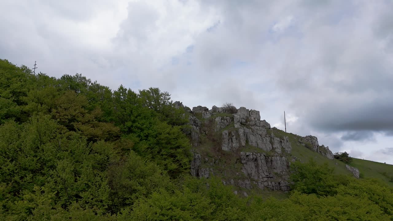 Reveal shot of Shipka Monument against a cloudy sky during springtime.