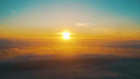 sunrise or sunset above the clouds