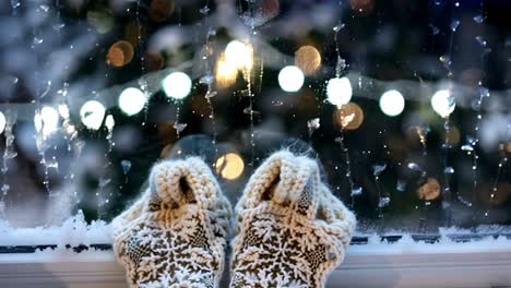 cozy feet by the window on a snowy christmas eve