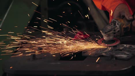 professional mechanic is cutting steel metal.