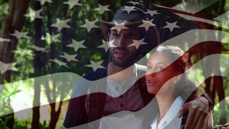 in forest, couple exploring with american flag animation overlay in foreground