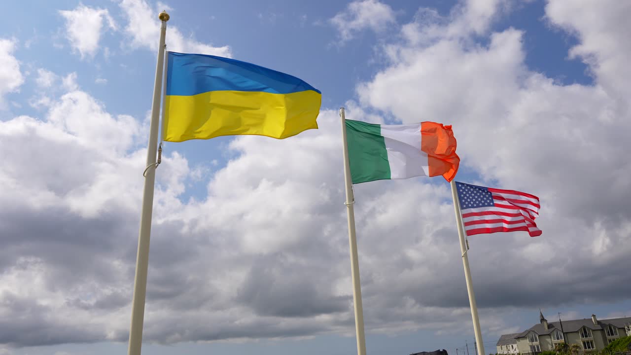 Static shot of Ukrainian, Irish and United States of America&acute;s flag waving