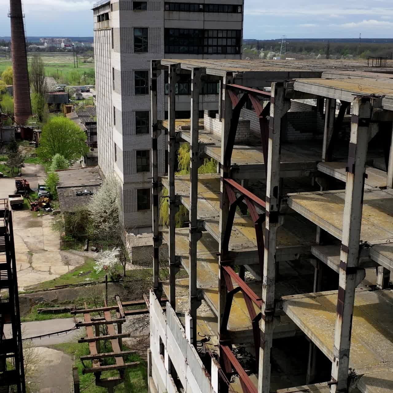 Destroyed buildings. Abandoned territory of an old industrial plant. Ancient factory with ruined buildings. Aerial flight