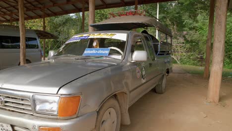 Static-close-up-of-an-old-dusty-Toyota-car-remodeled-to-be-a-safari-car-in-outdoor-garage