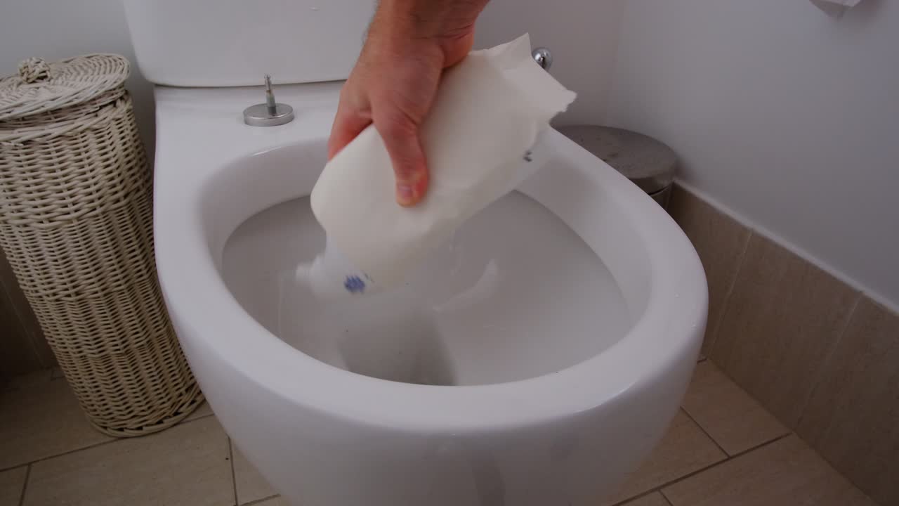 Cleaning toilet bowl with toilet brush