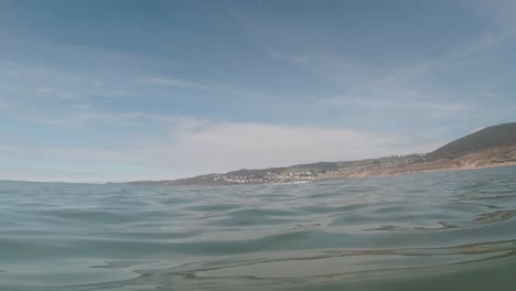 View-from-Sea-of-Small-Seaside-Resort-Town-from-Calm-Ocean-Beach