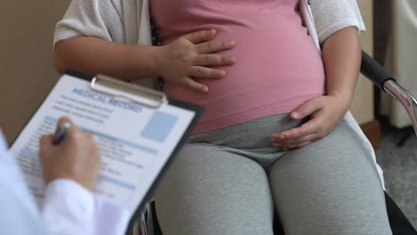 pregnant woman and gynecologist doctor at hospital