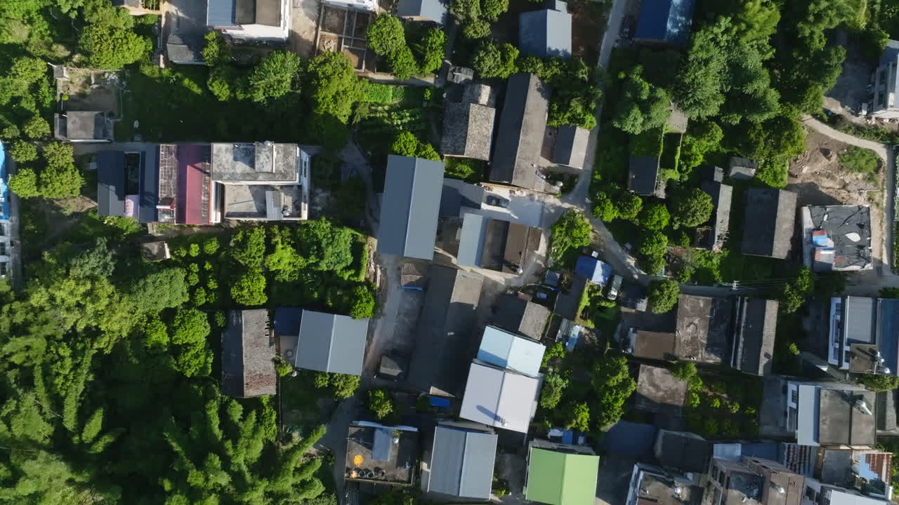 Birdseye drone shot rising above homes in Xingping Ancient Town, summer in China