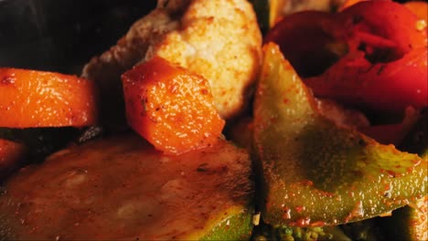 cinematic close-up macro shot of grilled vegetables medley including cauliflower, carrots and zucchini