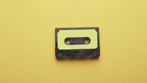 video of retro tape with yellow label with copy space on yellow background