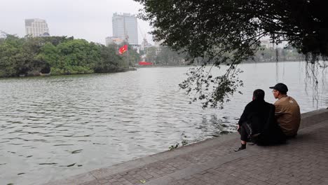 couple enjoys peaceful moment by the lake