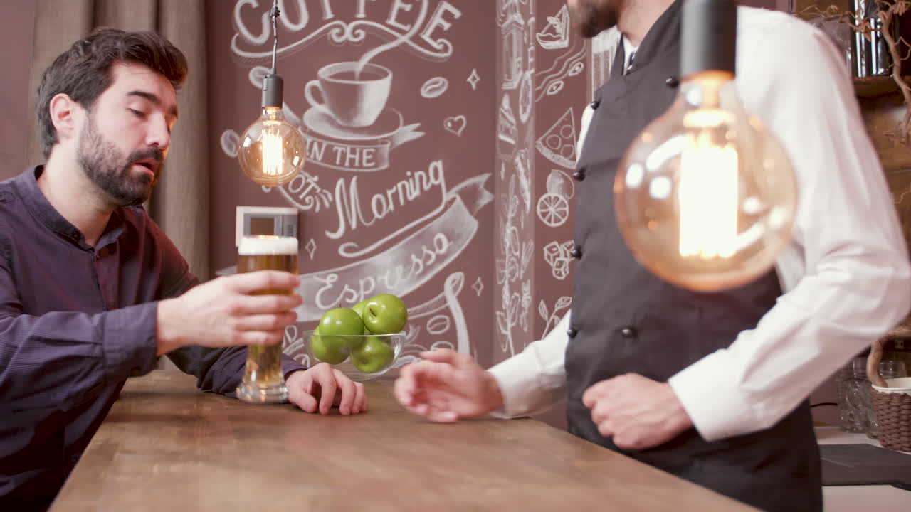 Man in bar being served a beer