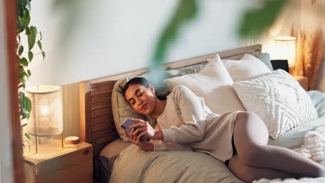 woman relaxing in bed with phone