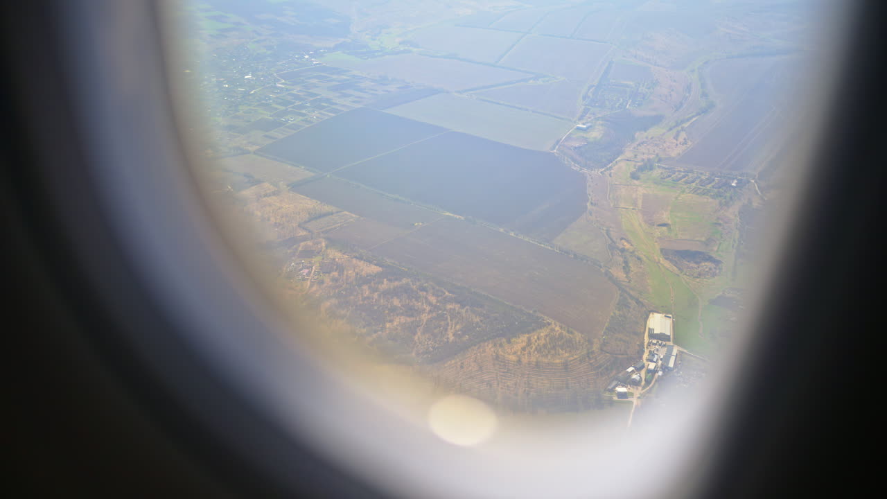 View of towns and fields in Moldova from an airplane window