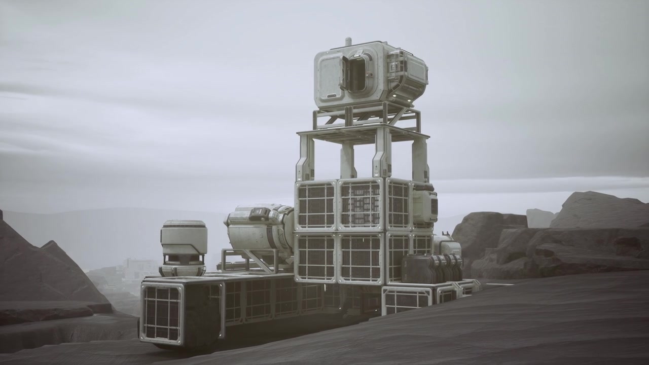 Modules stacked on rough ground beneath cloudy sky and mesas