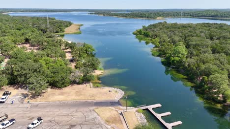 Moving-above-a-boat-ramp-parking-lot-that-is-in-a-small-lake-inlet