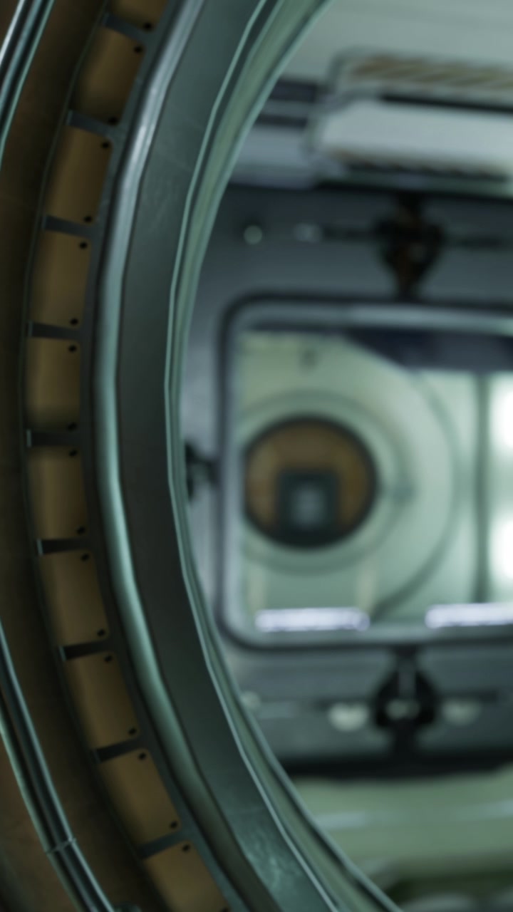 View of a space habitat module through a round window in a spacecraft