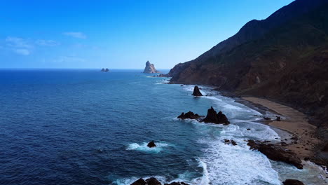 Flight over the waterscape of the Atlantic Ocean. Waves roll to the rocky coast of Tenerife, the Canary Islands, Spain
