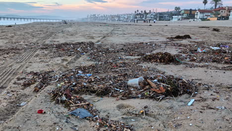 trash plastic waste and sea garbage on sandy manhattan beach california