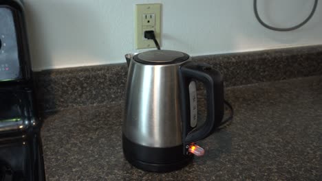 tea kettle being set to boil water for making coffee or tea