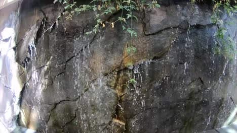 Zeitlupe---Indoor-Wasserfall,-Der-über-Eine-Kleine-Felswand-Fließt