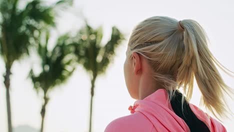 handheld view of female runner on the beach