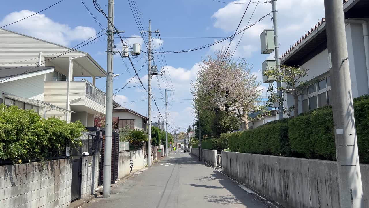 POV walking through typical residential area of Tokyo on sunny day