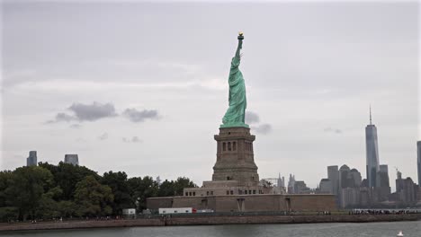 statue of liberty with new york skyline in the background