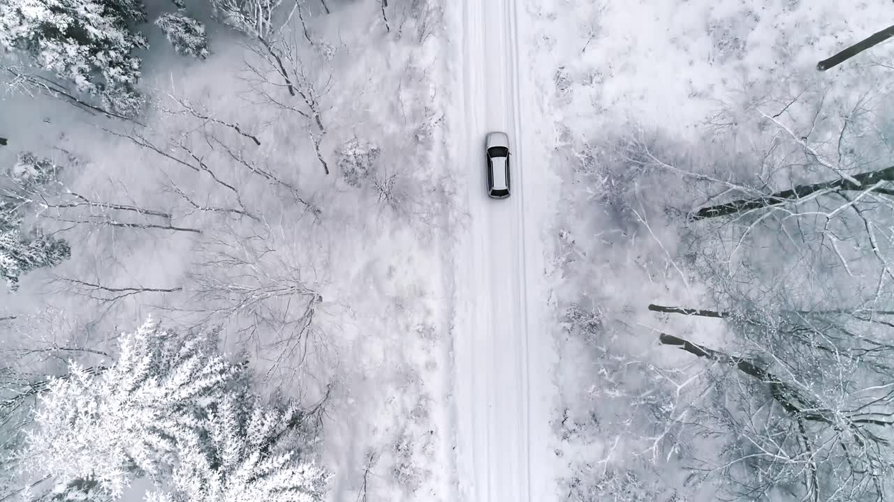 vista aérea del coche en la carretera en el bosque de invierno