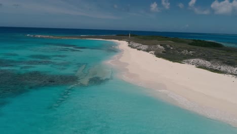 Lighthouse-tropical-island,-aerial-shot-turn-around-beach-scenery,-cayo-de-agua-Los-Roques