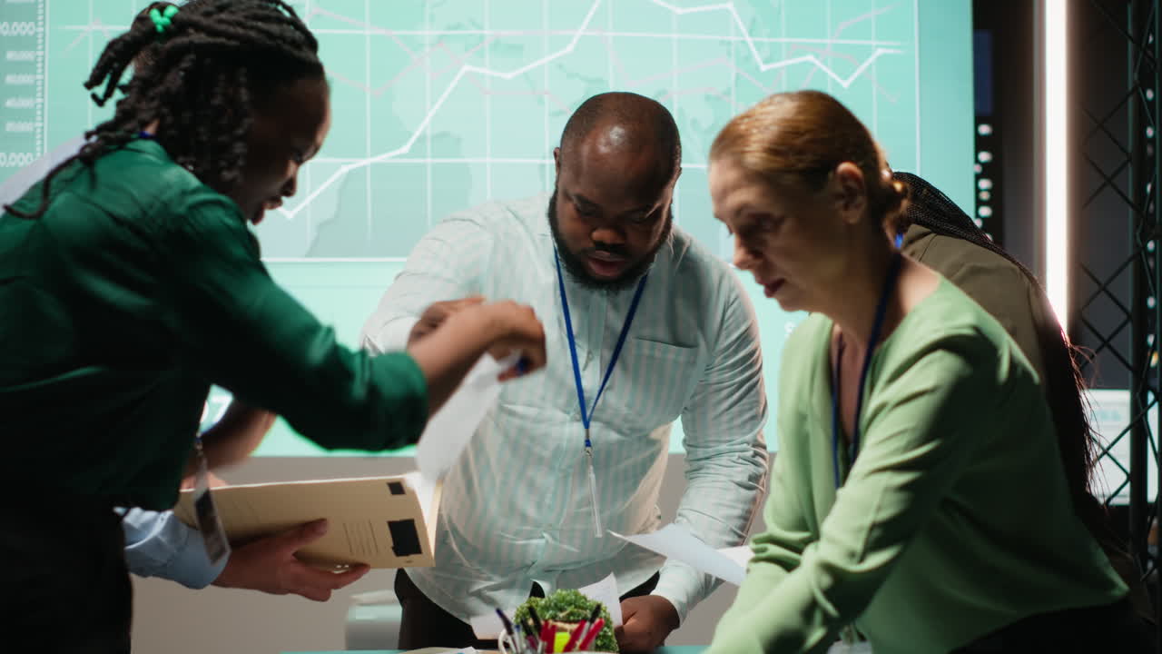 Diverse group of staff collaborating on a company briefing after hours