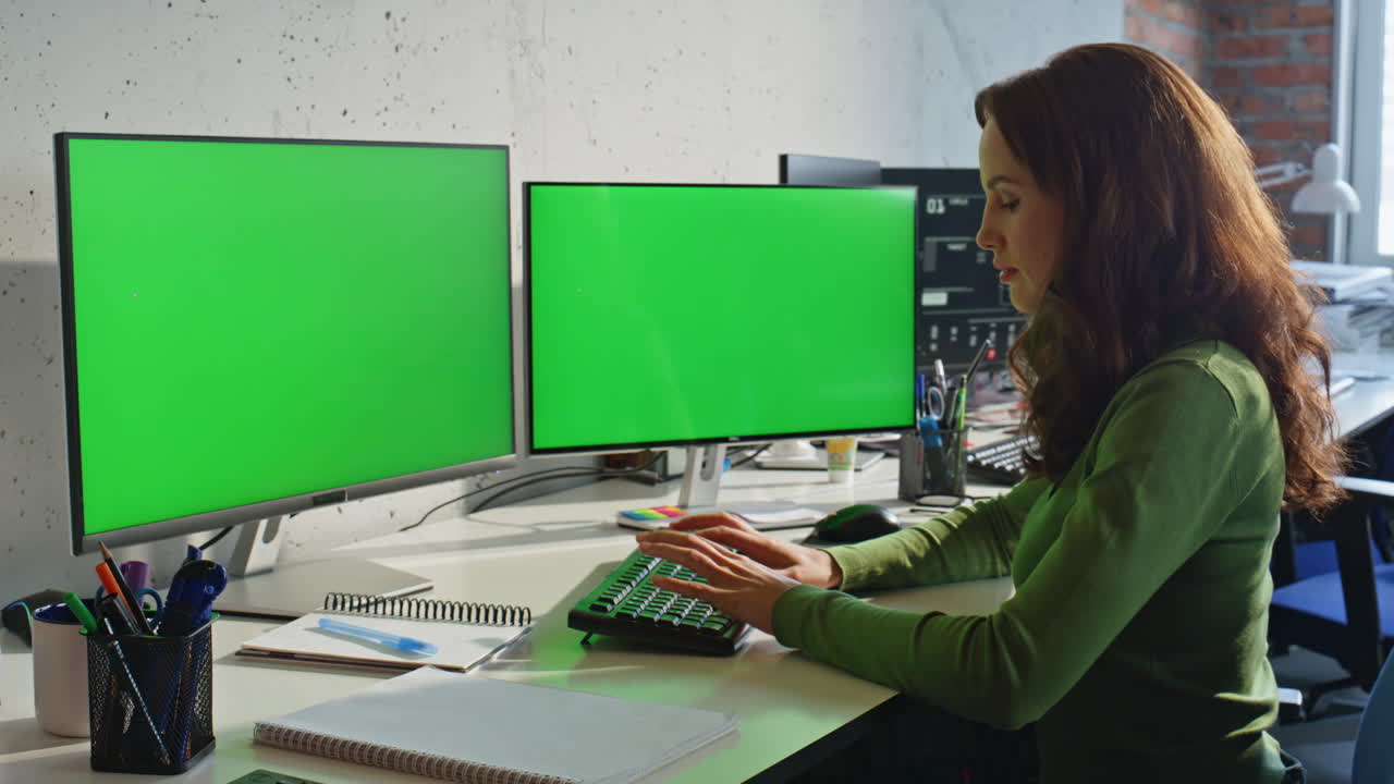 Businesswoman texting mockup pc at work desk closeup. Lady watching two displays