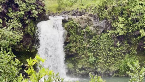 cinematic booming up shot of upper waikani falls along the road to hana on the island of maui, hawai'i