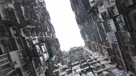 pov looking up at urban density at quarry bay monster building in hong kong