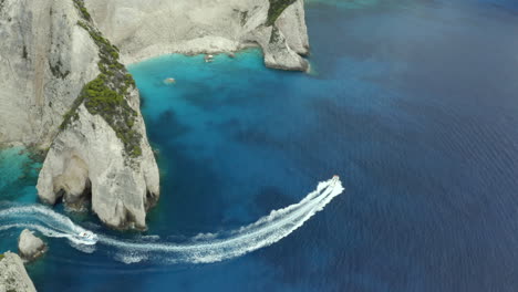 drone shot of boat on a boat your near shipwreck beach in zakynthos, greece