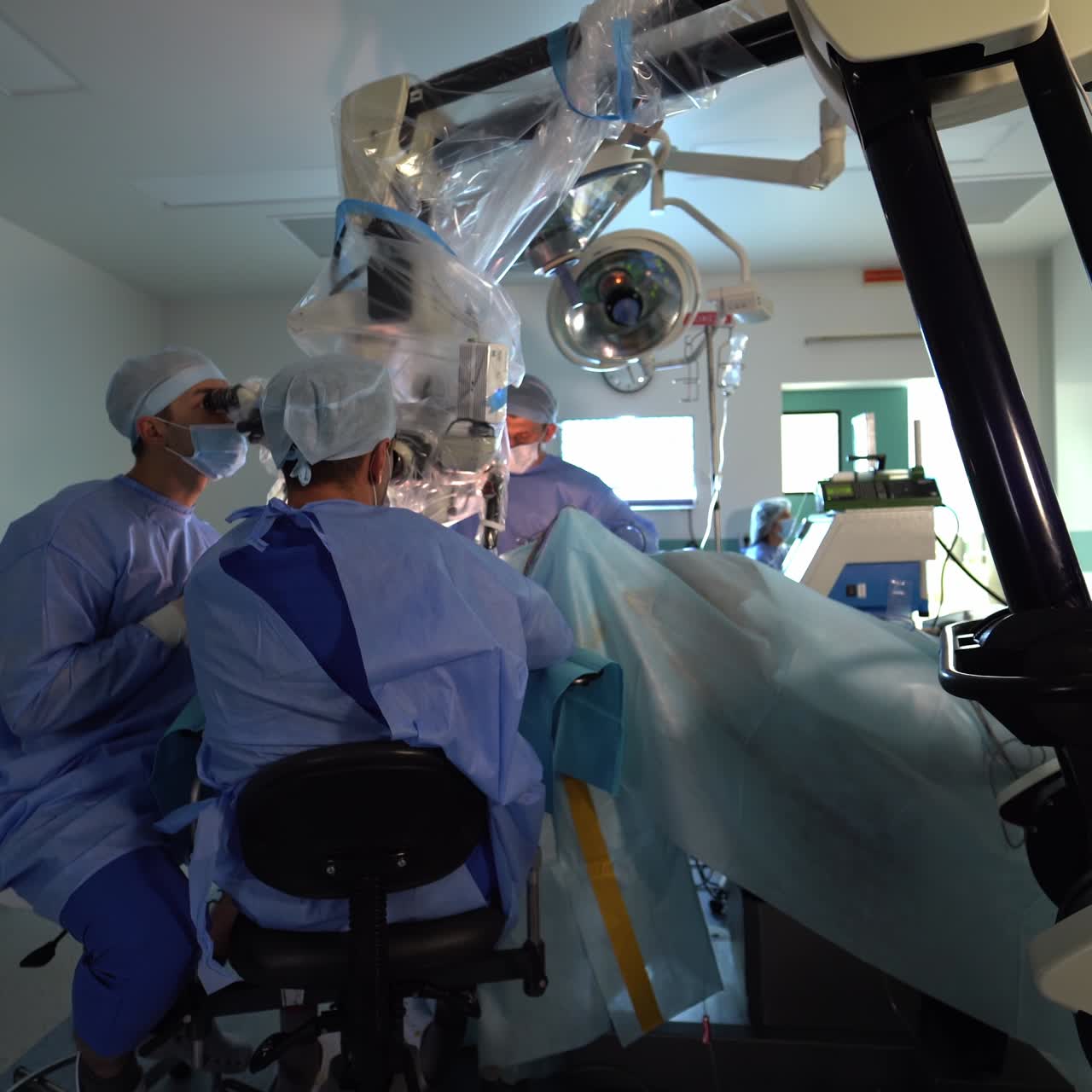 Highly-equipped technological surgery theatre. Neurosurgeon professional team conducting operation sitting on chairs