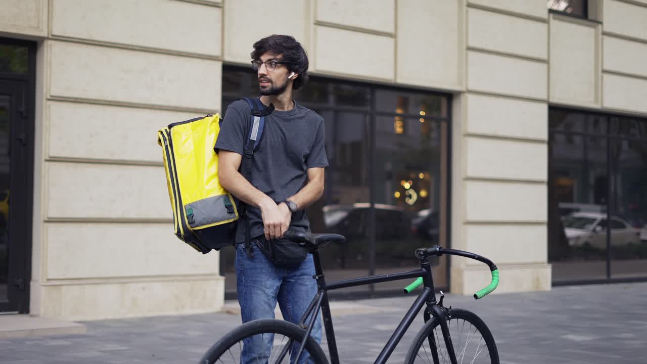 Courier with backpack look inside for details on order receipt