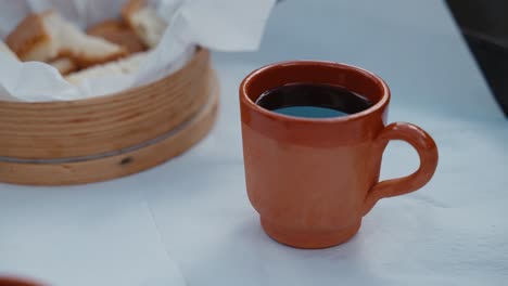 rustic terracotta cup with red wine and bread