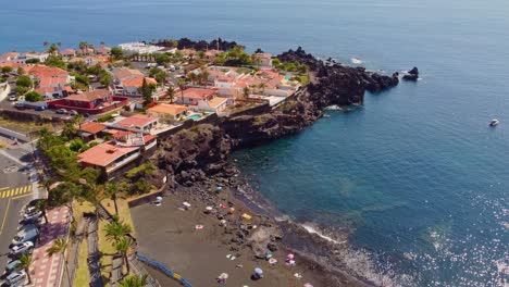 flying above peaceful volcanic black beach la arena on coast of tenerife