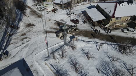 grader plowing snow in the village