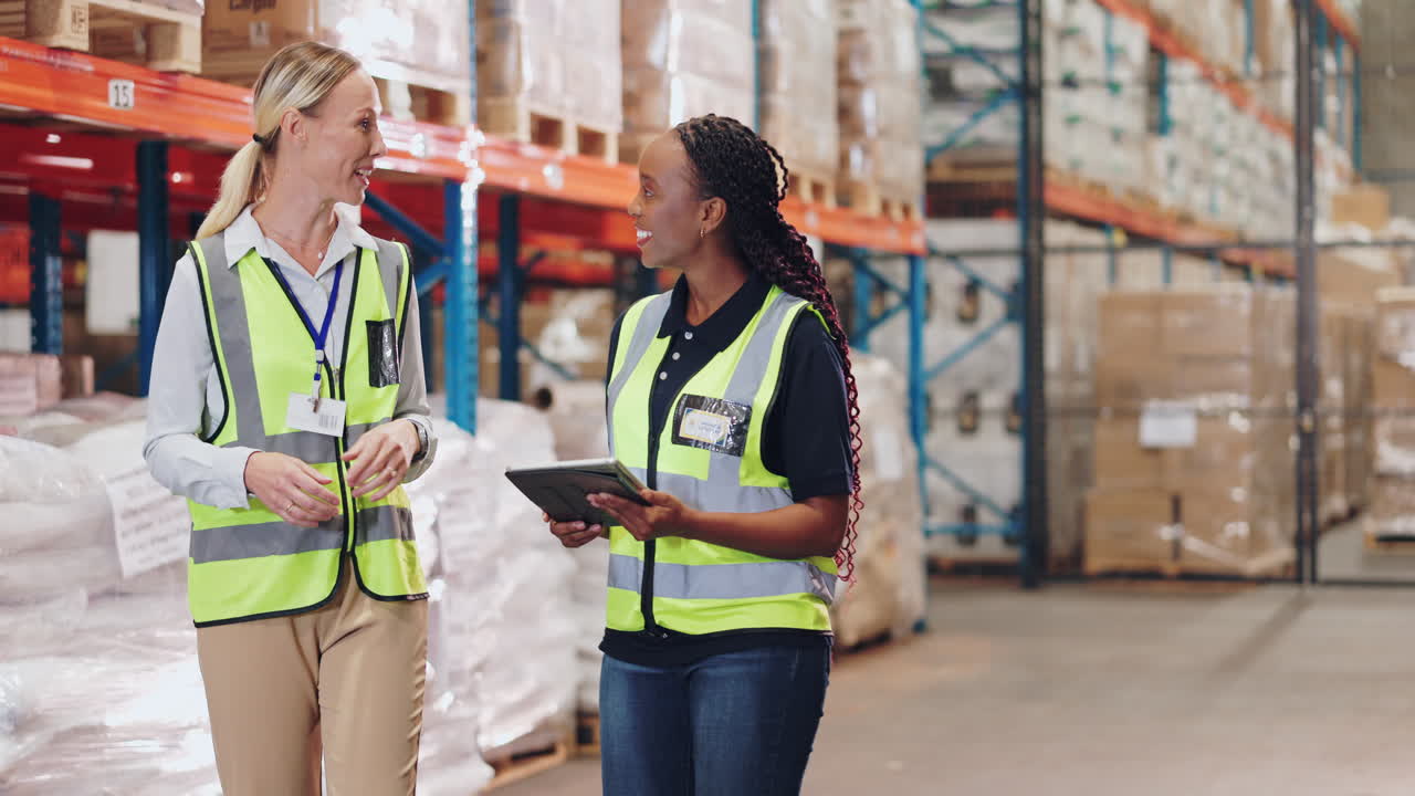 Warehouse employees discussing inventory