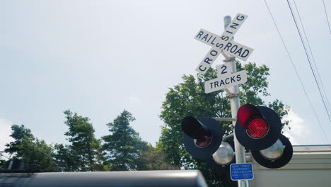 Traffic-Light-At-The-Railway-Crossing-A-Train-Passes-By