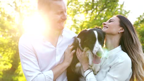 romantic couple in love walking dogs in nature and smiling