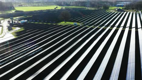 cinematic aerial shot of solar panels in grass field in the netherlands